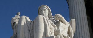 Marble statue of a woman sitting